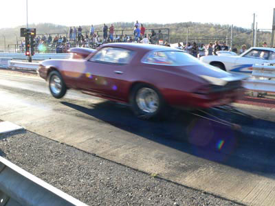 red camaro in wheelie