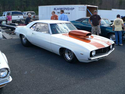 white camaro with orange race stripes